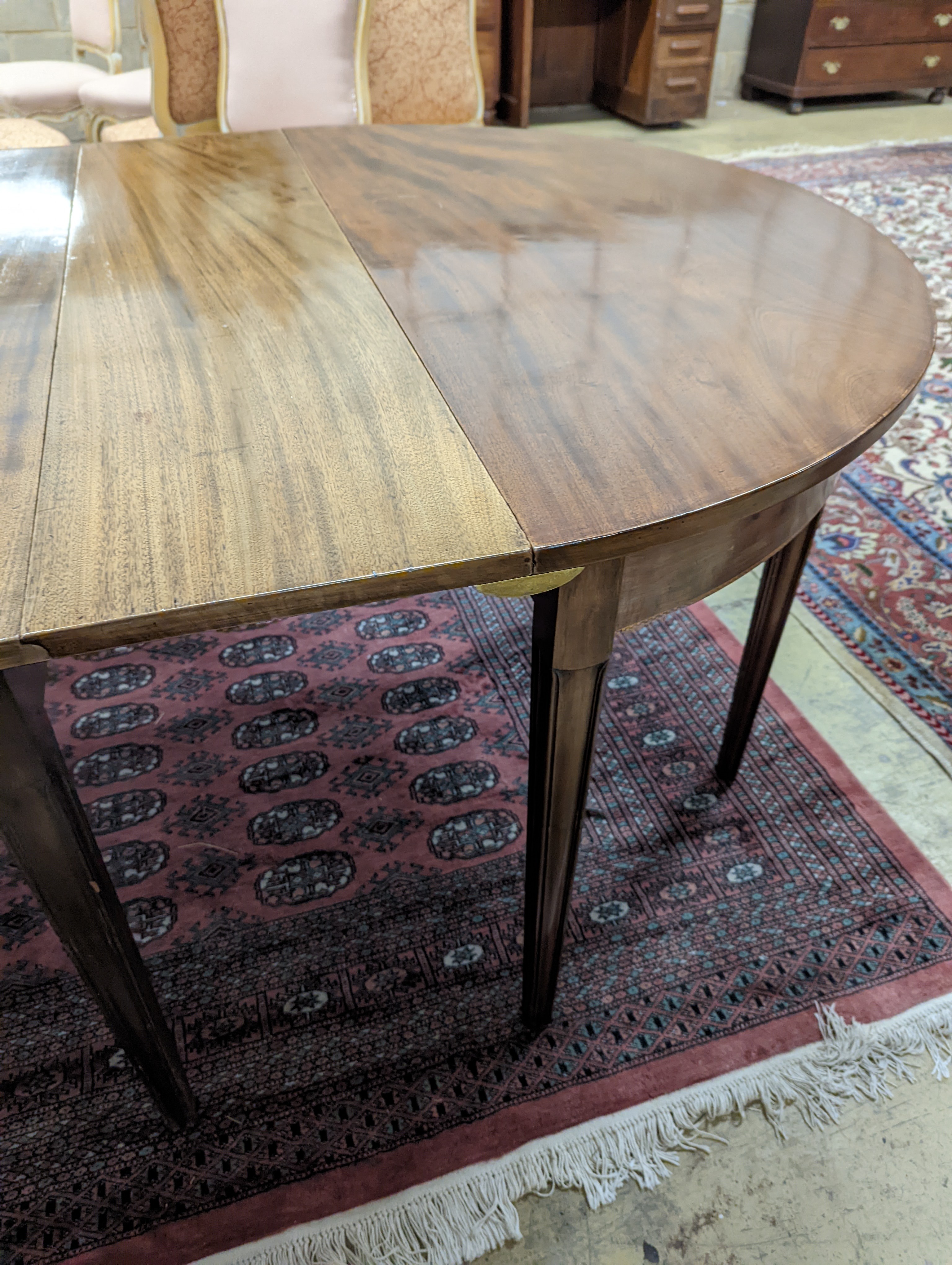 A George III mahogany D end extending dining table, with drop flap central section, length 240cm extended, width 120cm, height 76cm